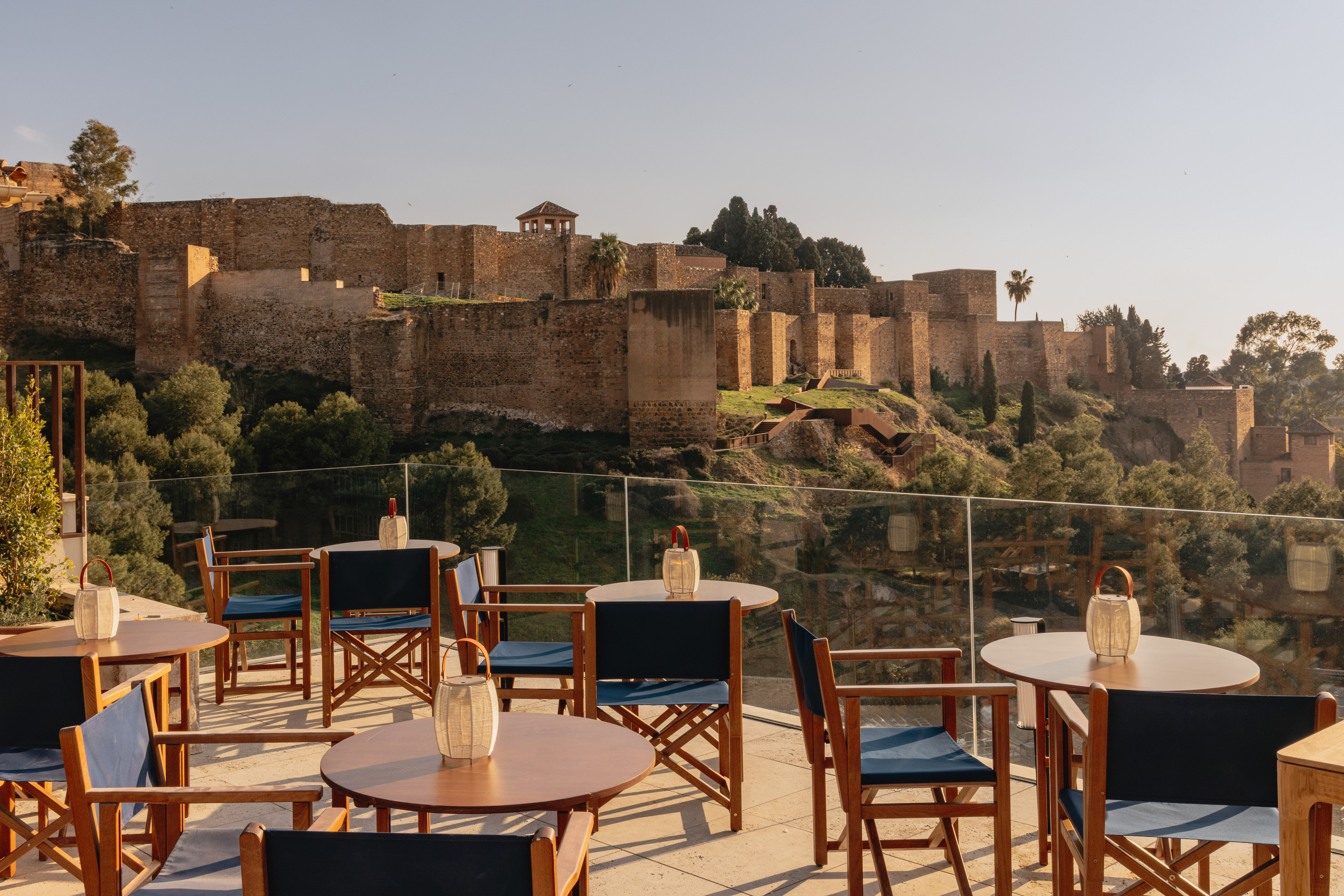 a table and chairs on a patio with a castle in the background