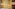 Luxury hotel lobby: marble reception, crystal chandeliers, gold Mayan mural.