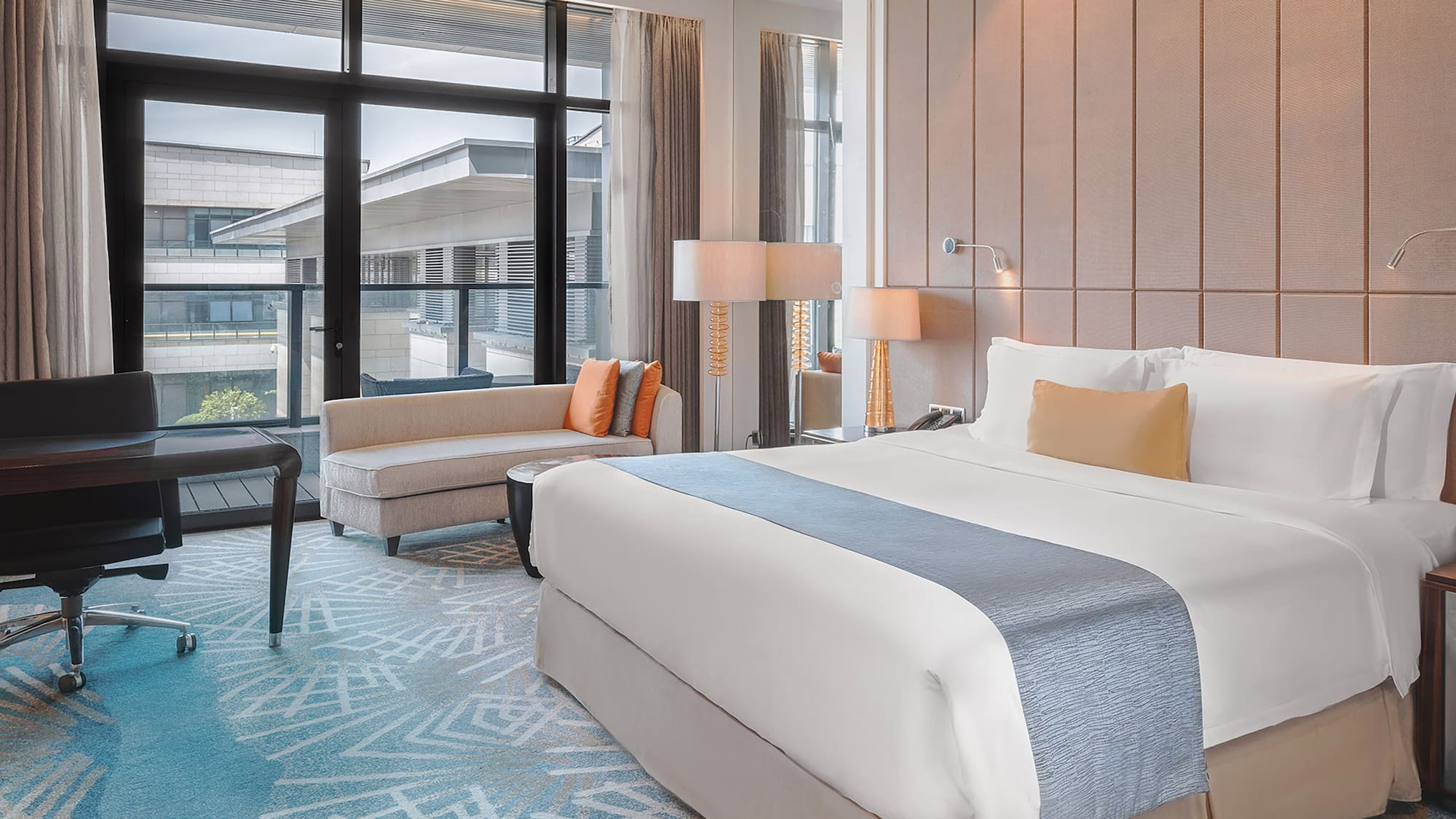 a room with a bed and chairs