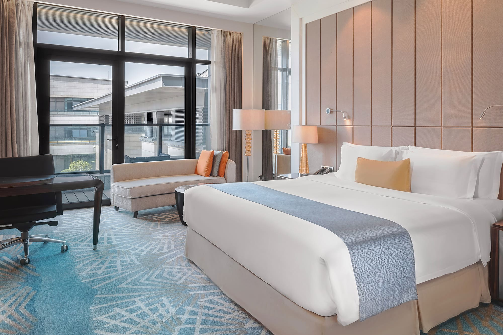 a room with a bed and chairs