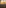 Golden sunbeams through clouds over vast savanna landscape with winding rivers at sunrise.