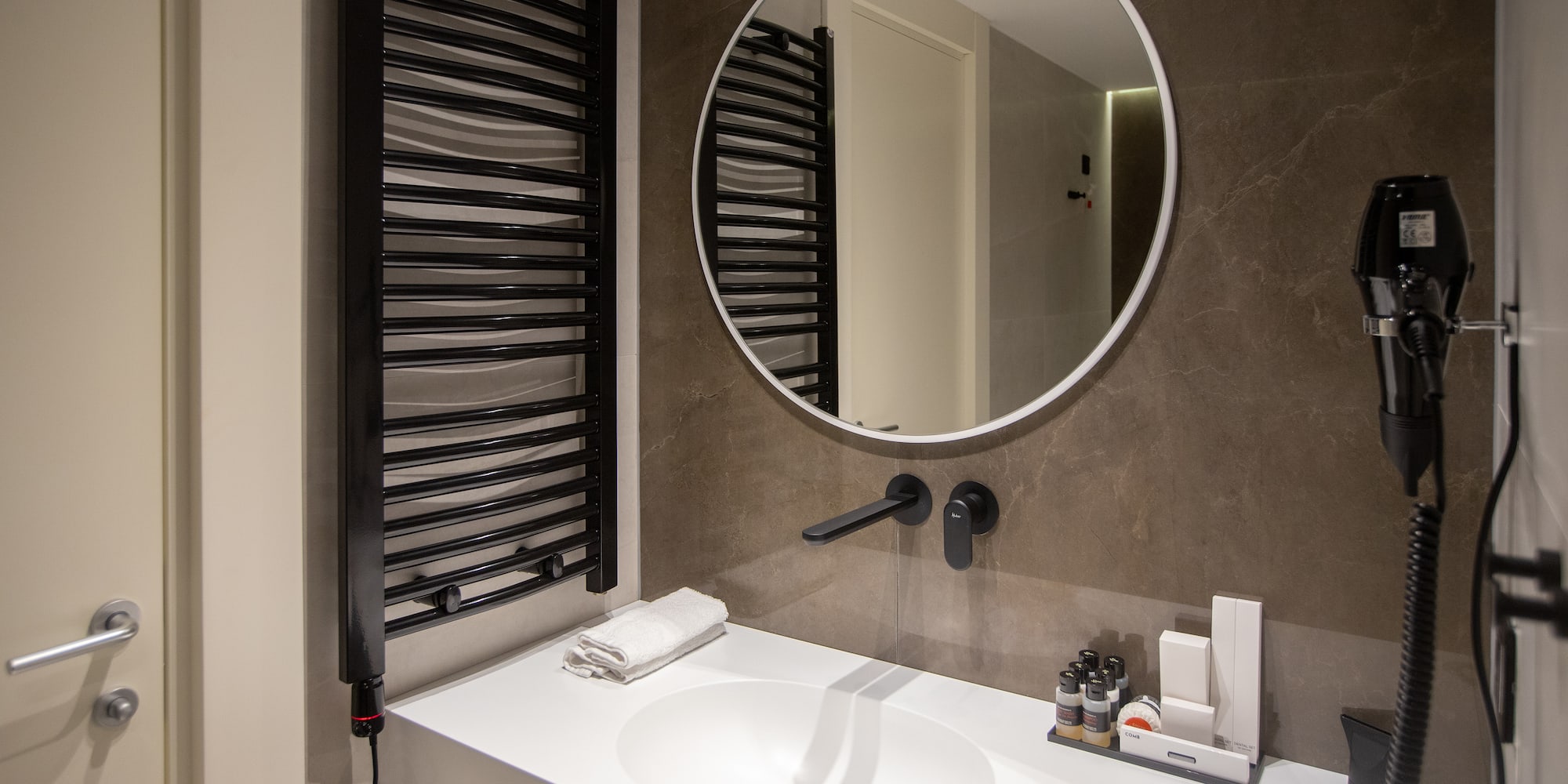 a bathroom with a round mirror