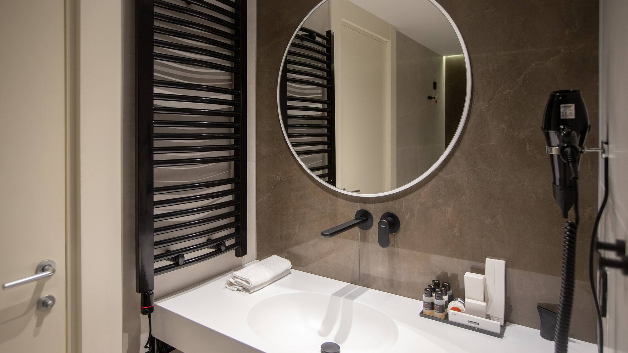 a bathroom with a round mirror