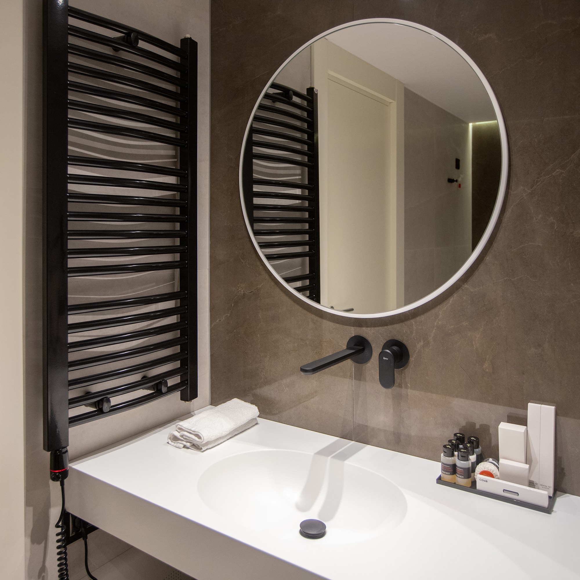 a bathroom with a round mirror