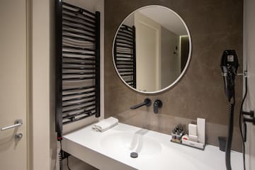 a bathroom with a round mirror