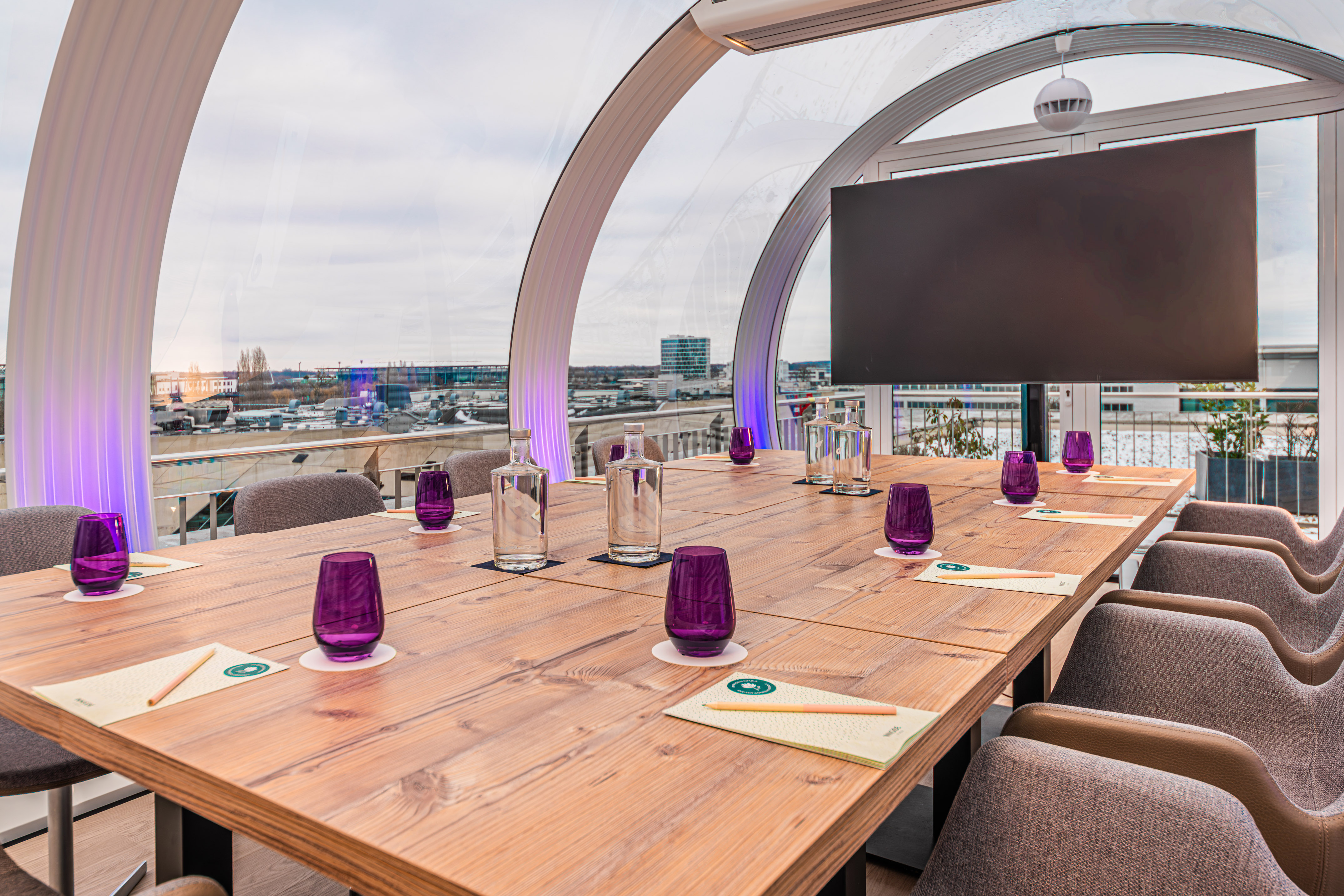 a table with purple glasses and a television on it