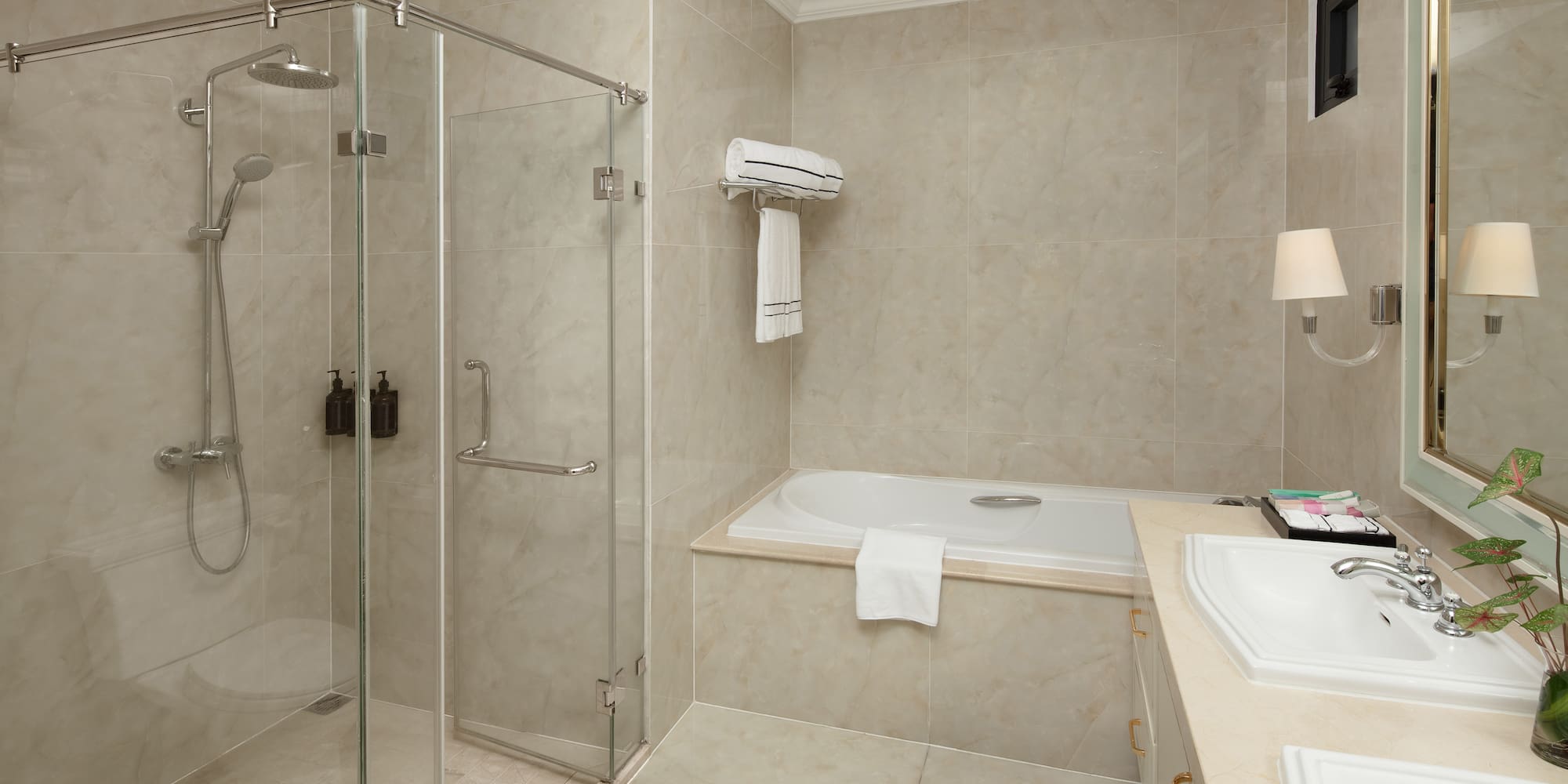a bathroom with a glass shower and tub