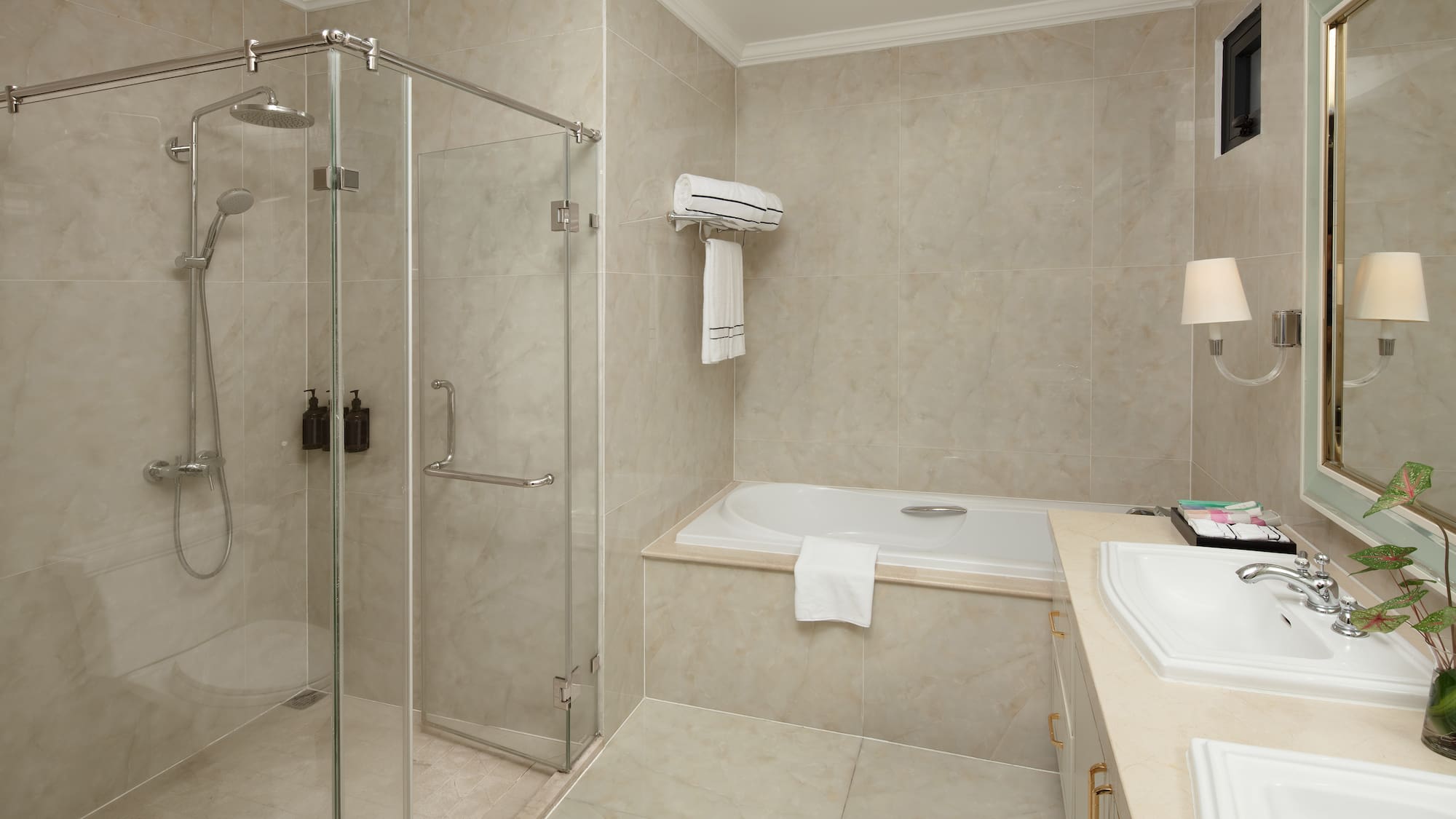 a bathroom with a glass shower and tub