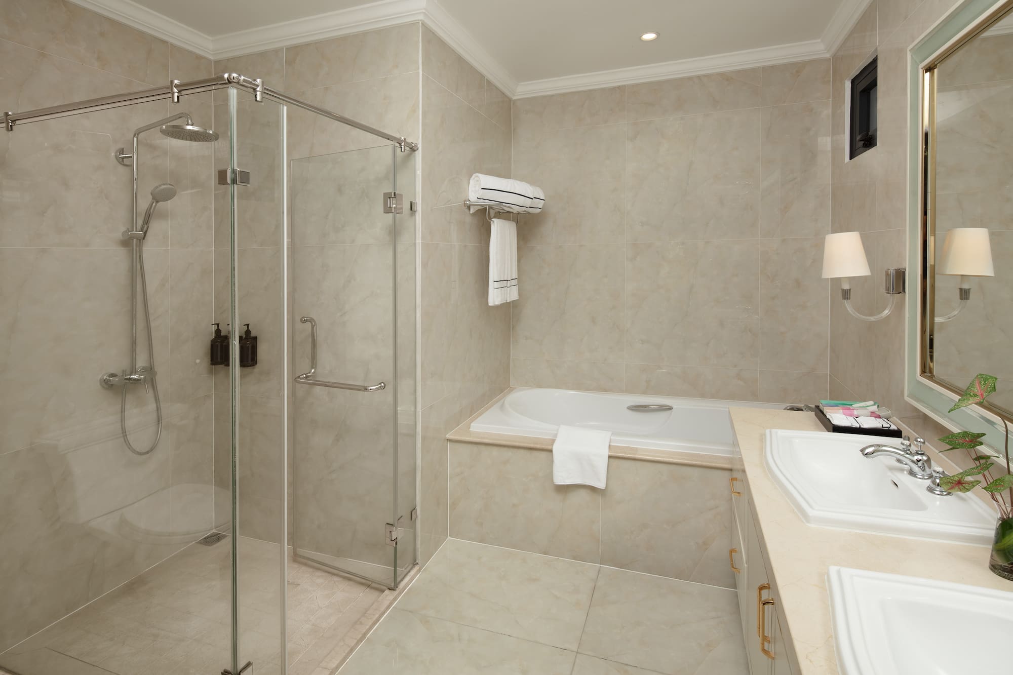 a bathroom with a glass shower and tub