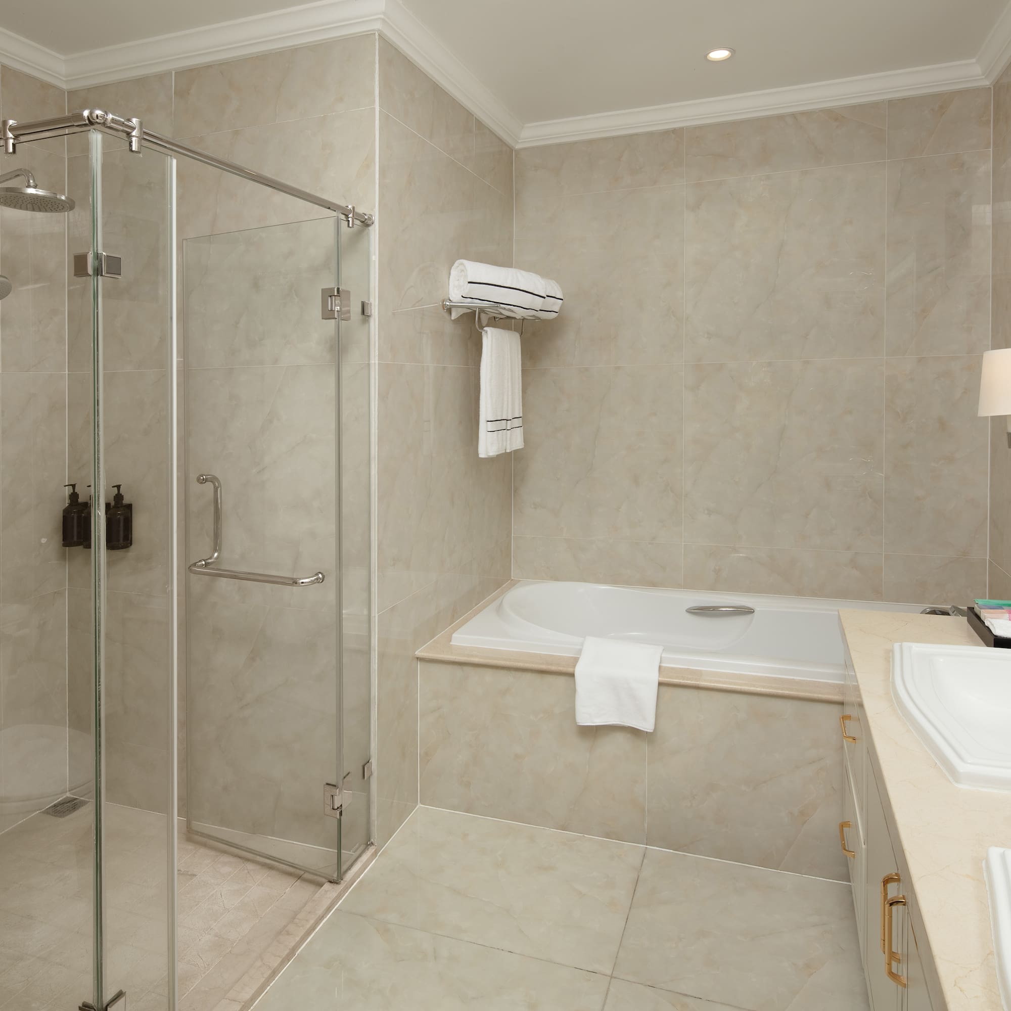 a bathroom with a glass shower and tub