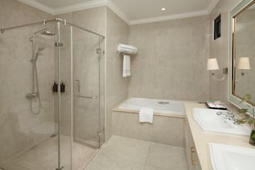 a bathroom with a glass shower and tub