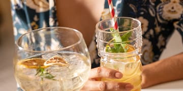 a woman holding a glass of liquid