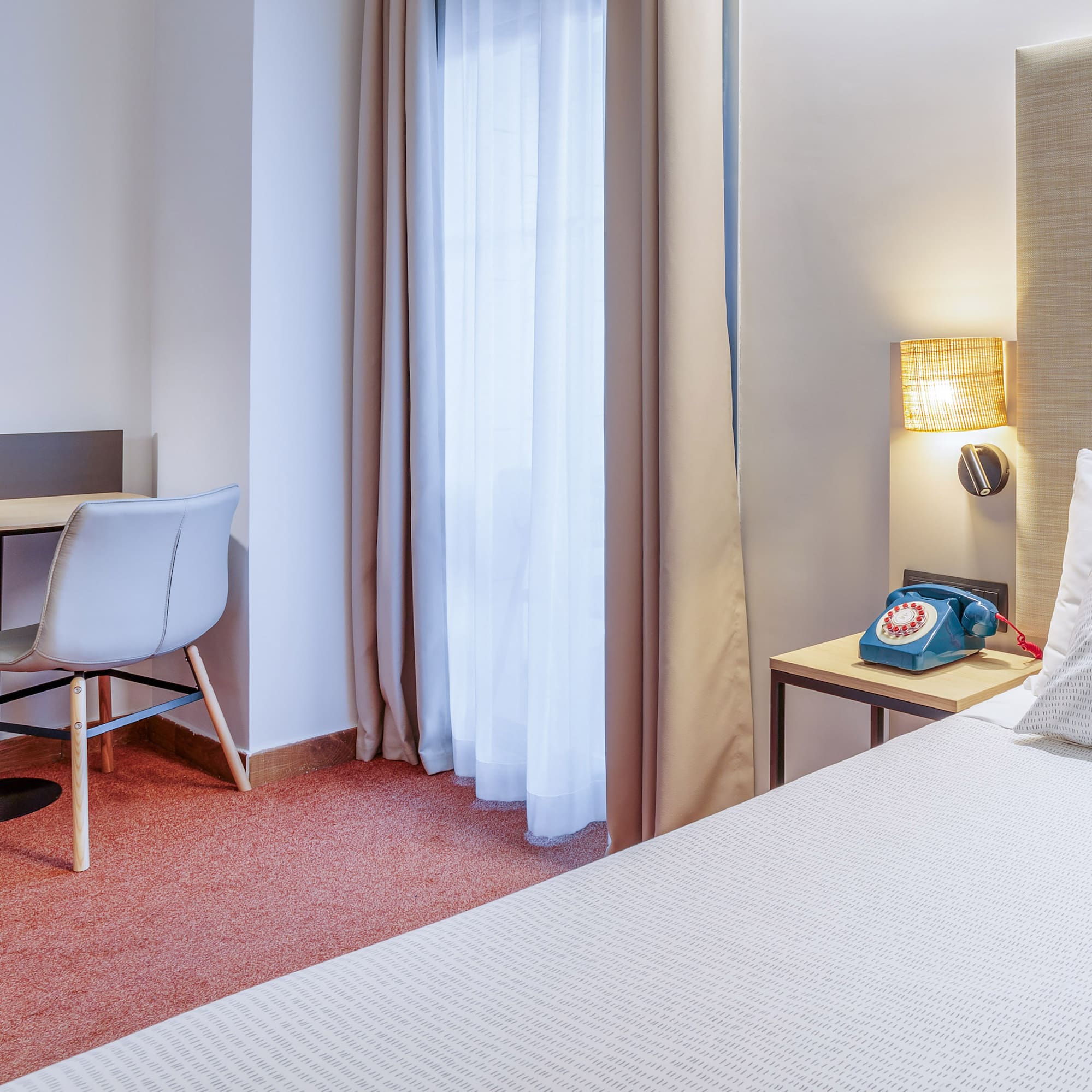 a room with a bed and a desk and chair