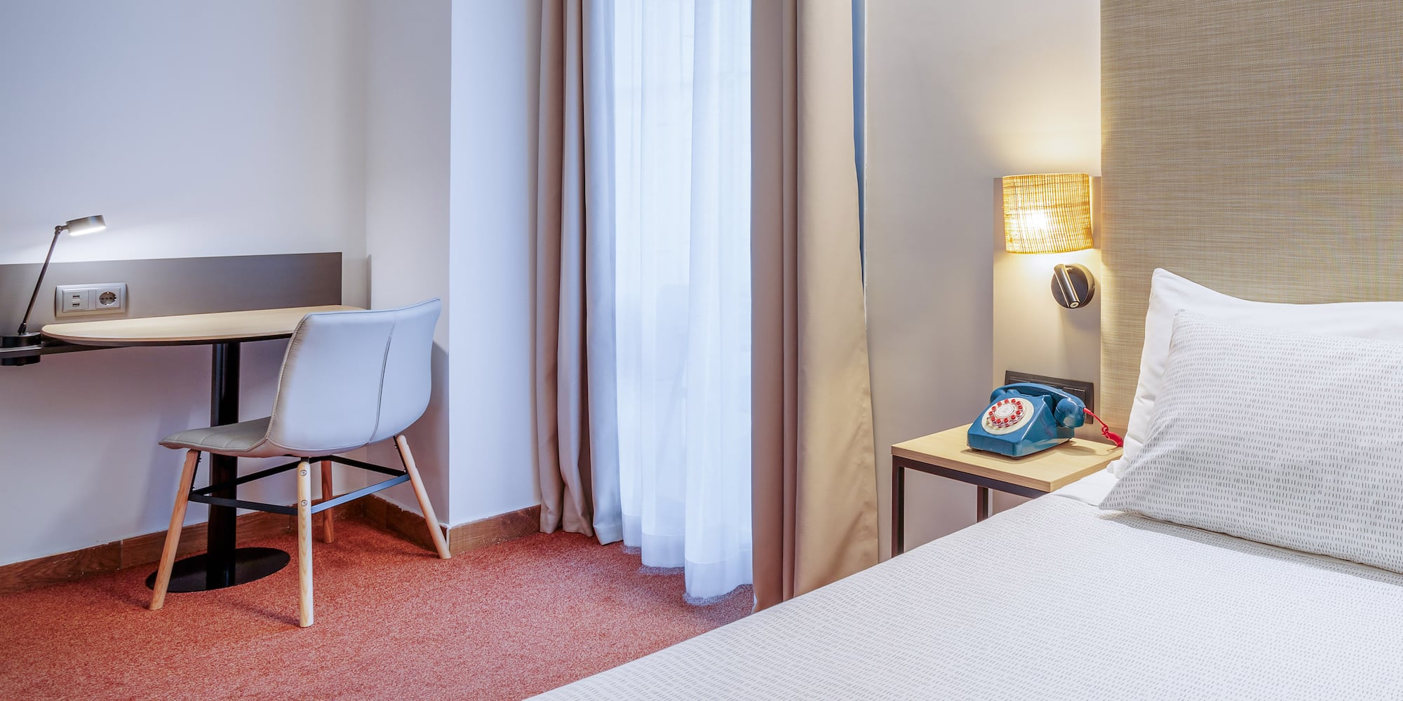 a room with a bed and a desk and chair