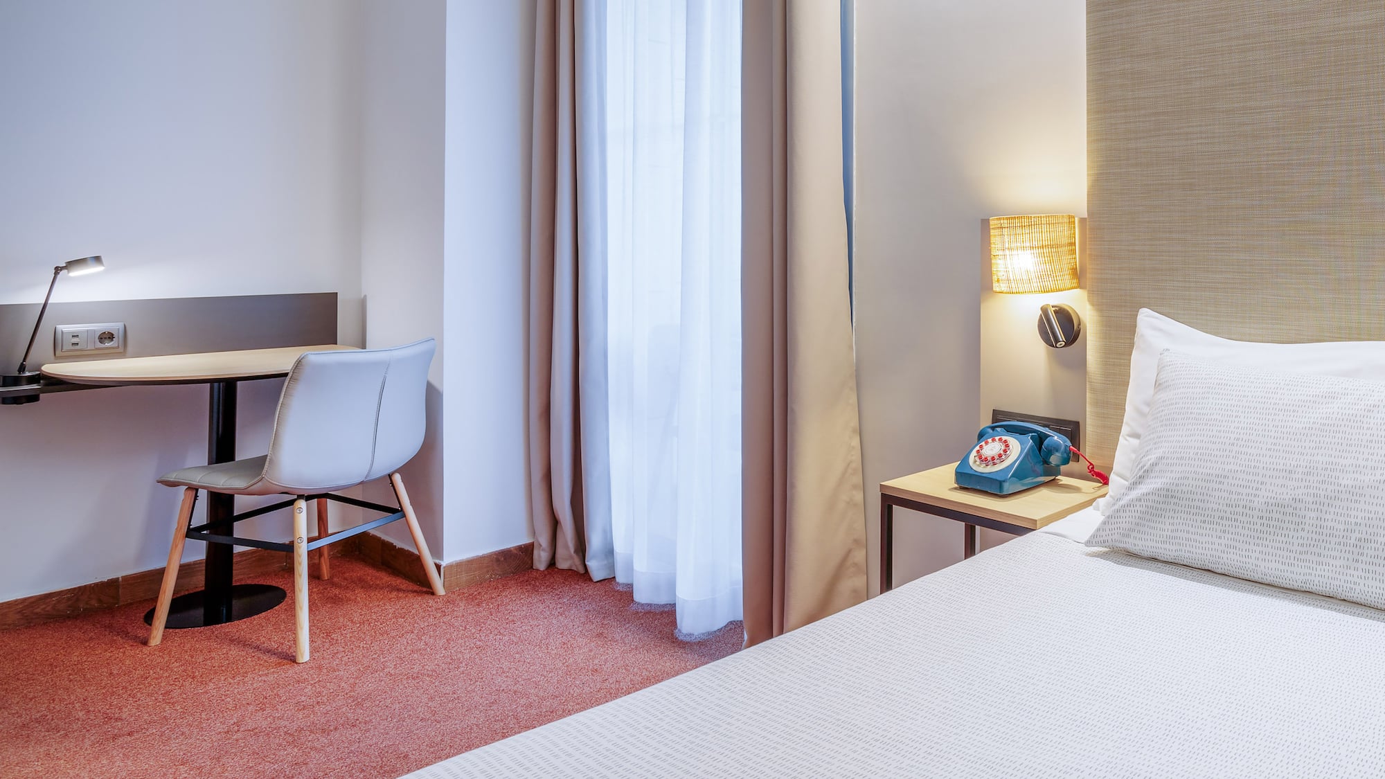 a room with a bed and a desk and chair