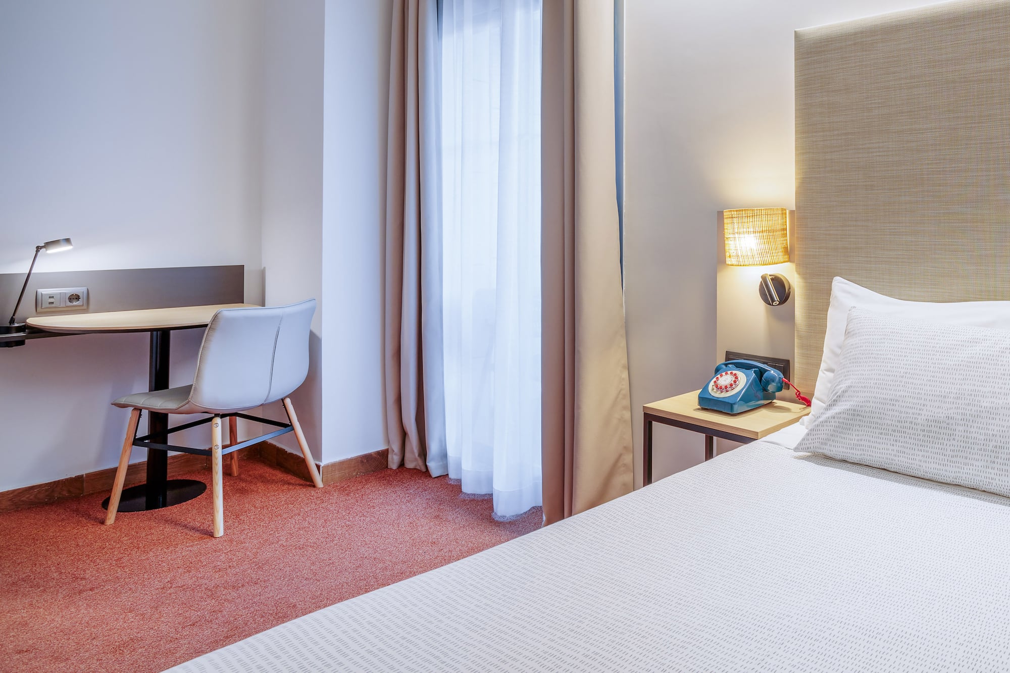 a room with a bed and a desk and chair