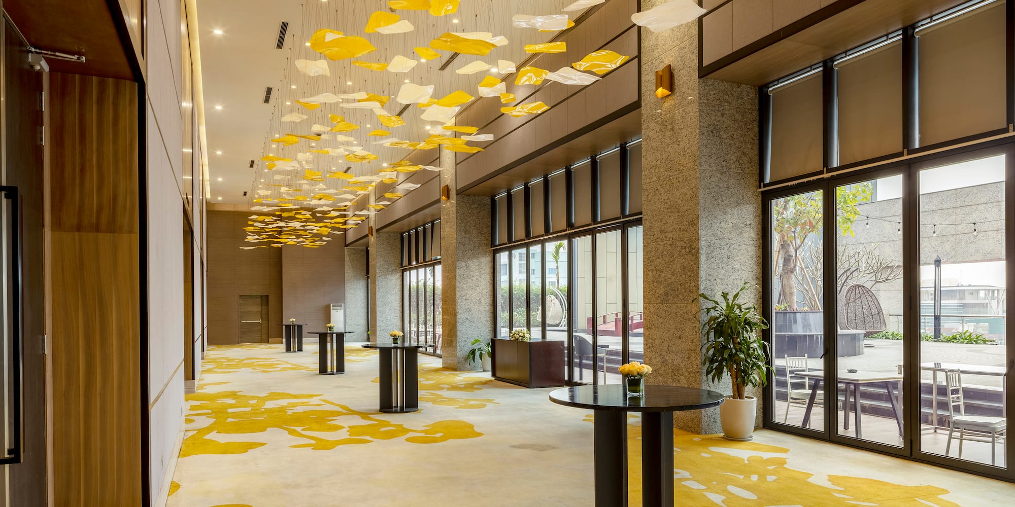 a room with a round table and yellow and white decorations