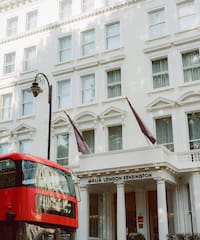 a double decker bus in front of a white building