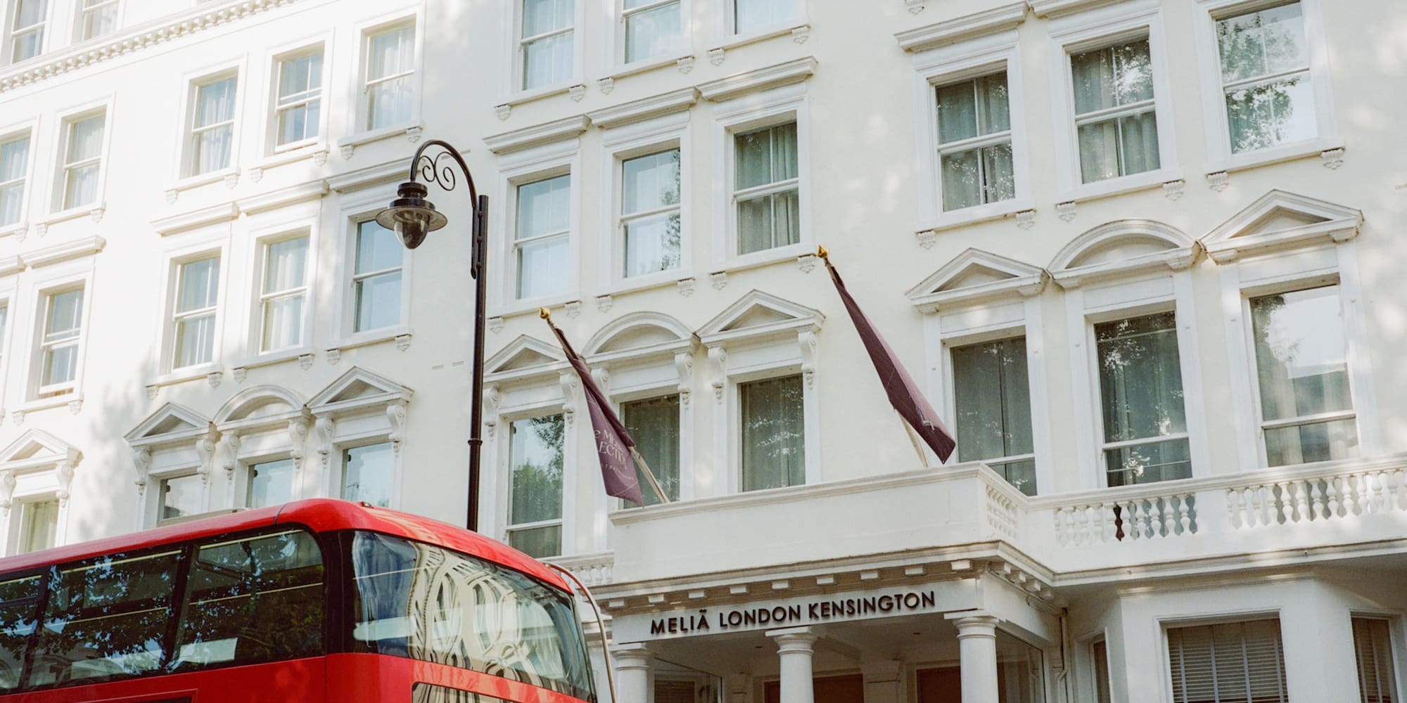 a double decker bus in front of a white building