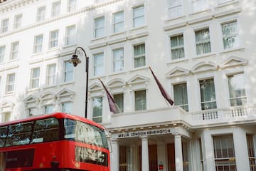 a double decker bus in front of a white building
