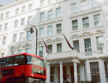 a double decker bus in front of a white building