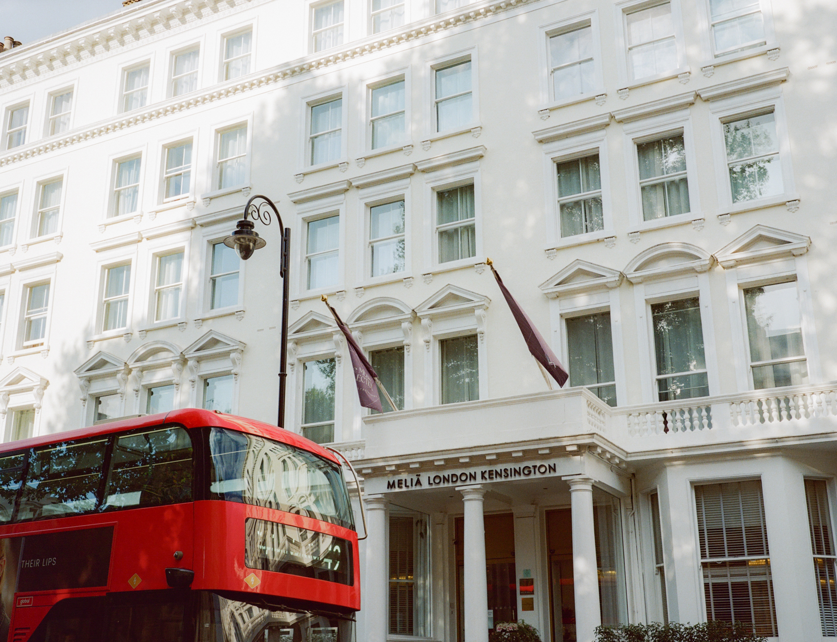 a double decker bus in front of a white building