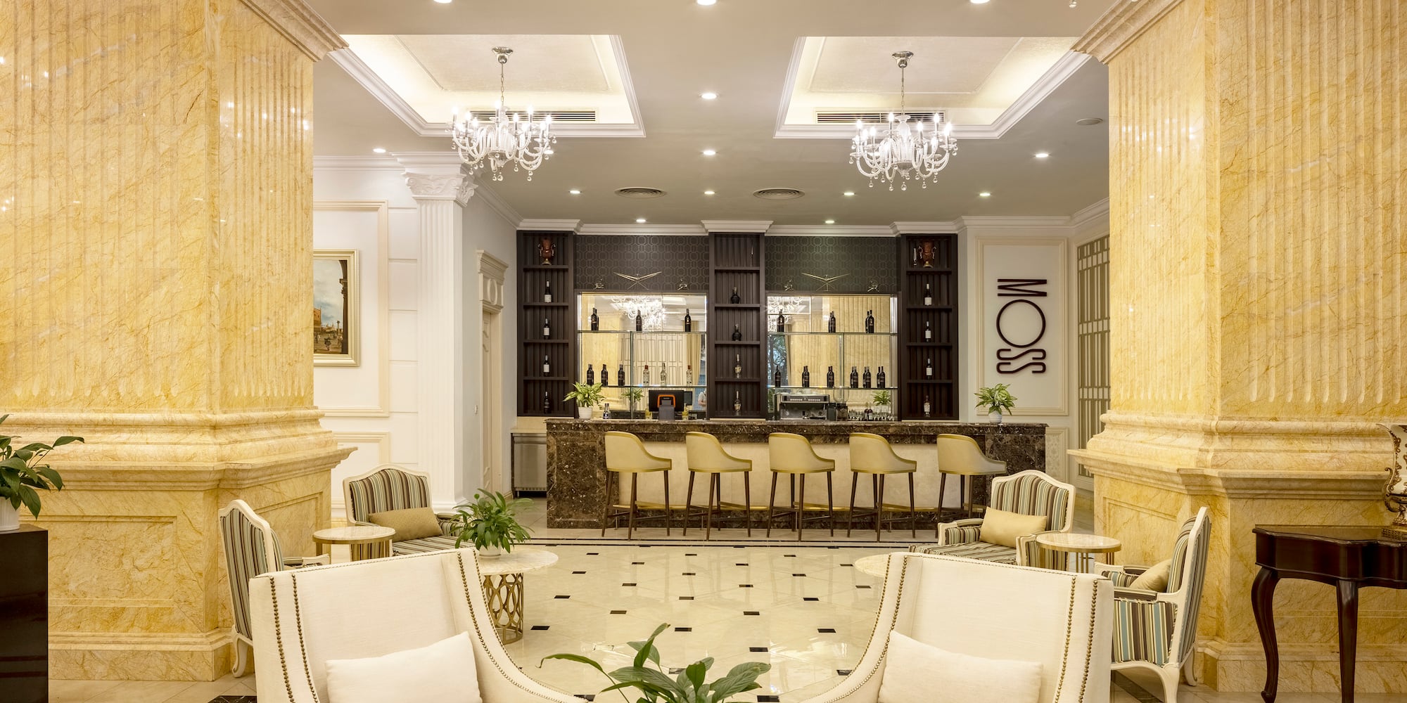 a room with white chairs and a table