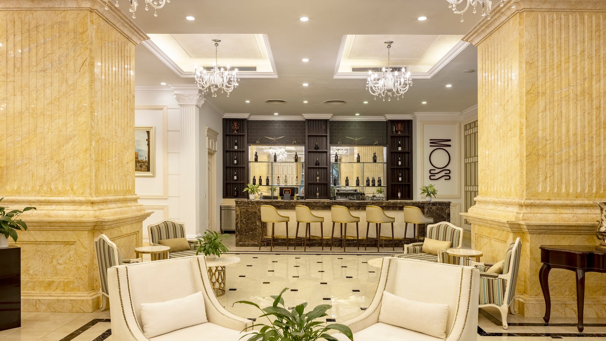 a room with white chairs and a table