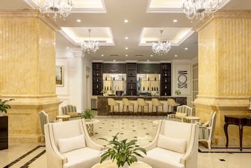 a room with white chairs and a table