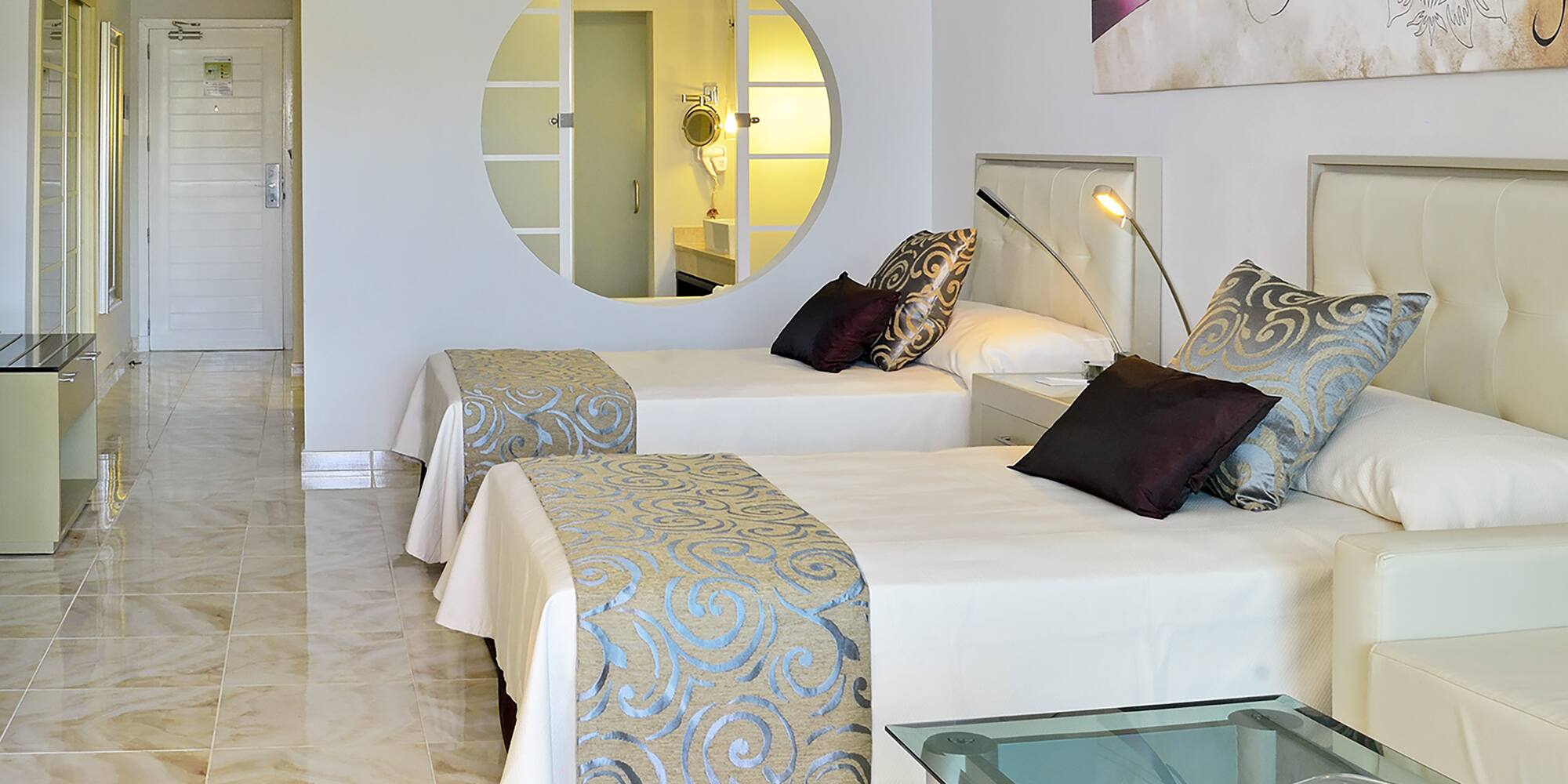 a room with two beds and a mirror