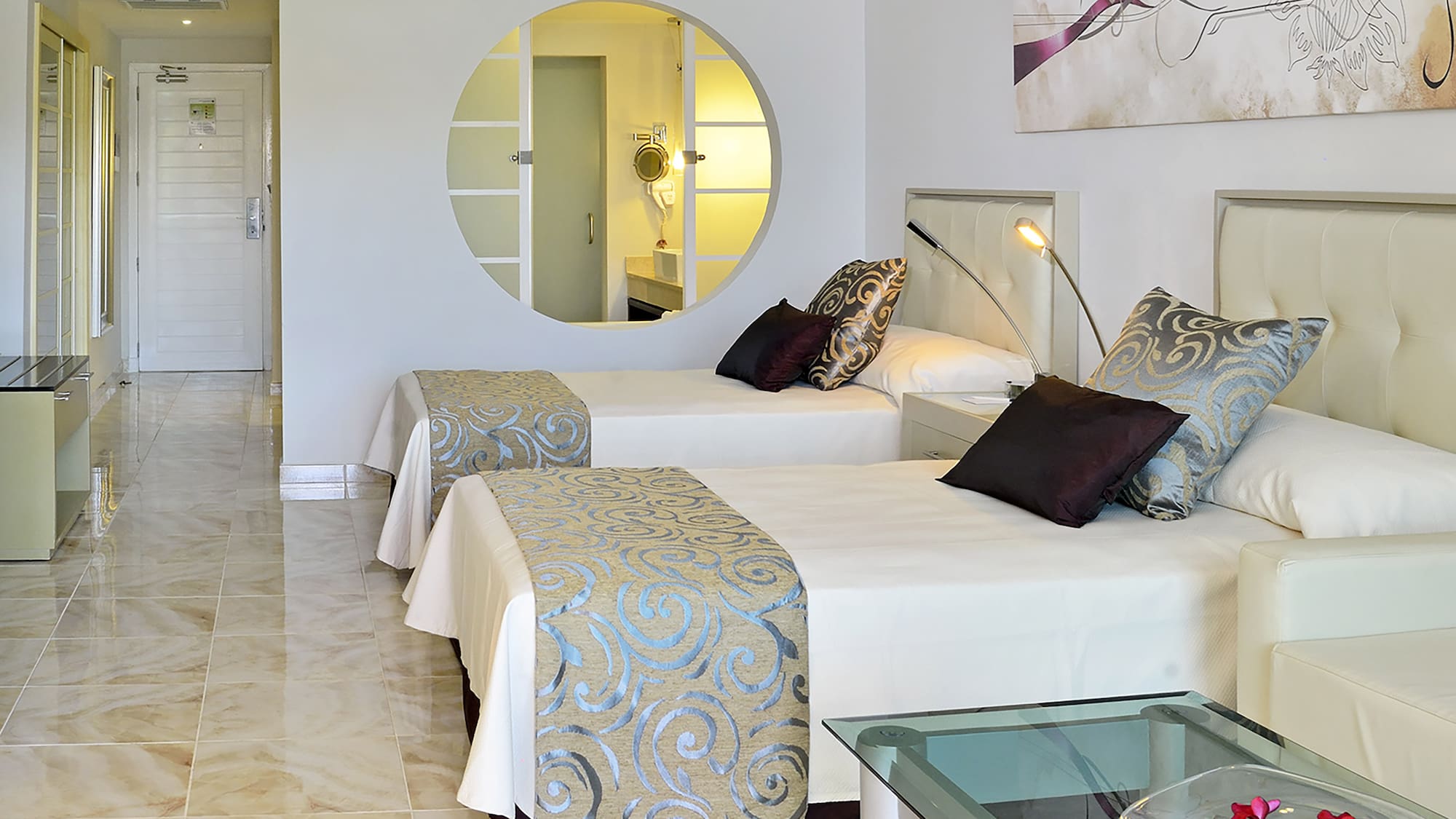 a room with two beds and a mirror