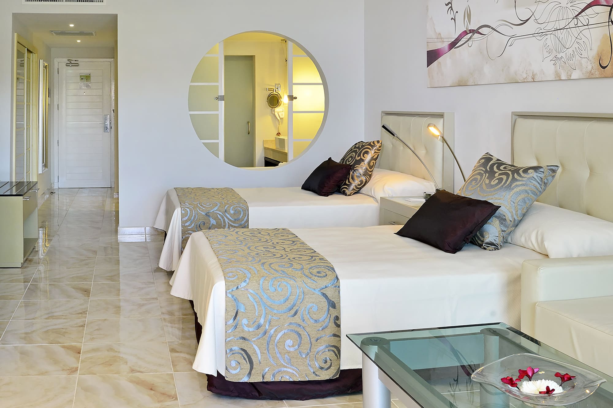 a room with two beds and a mirror