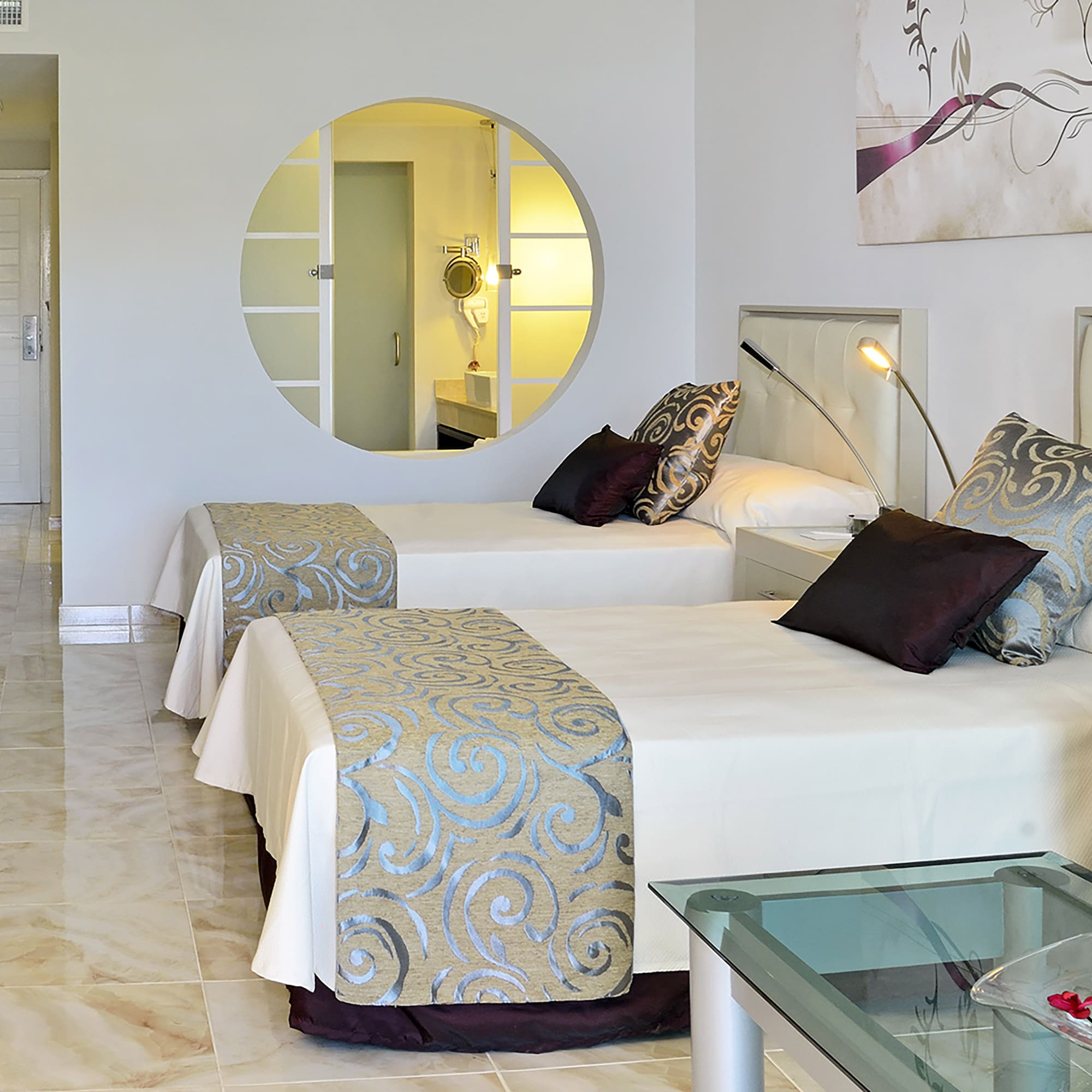 a room with two beds and a mirror