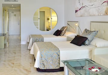 a room with two beds and a mirror