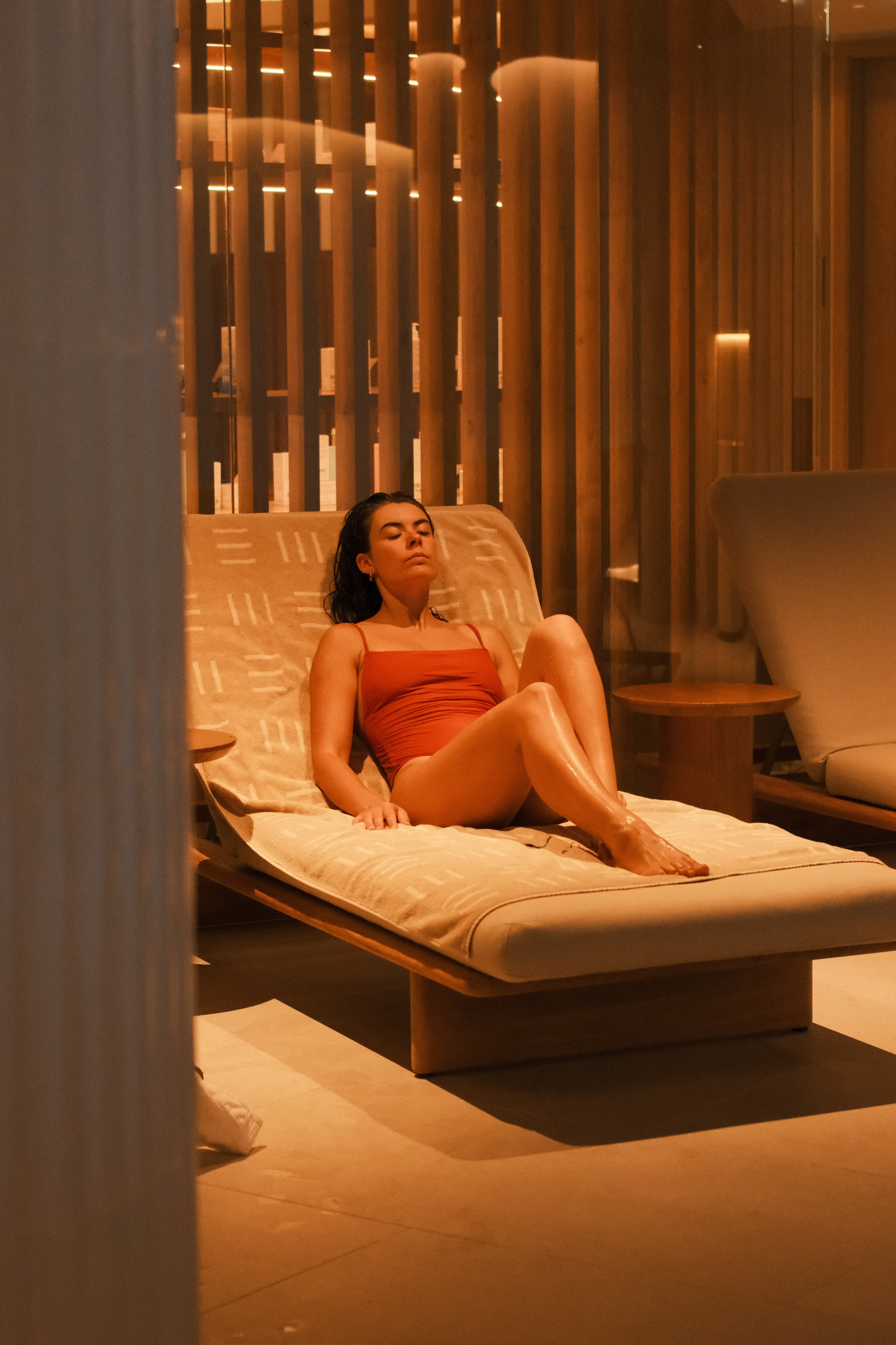 a woman lying on a lounge chair