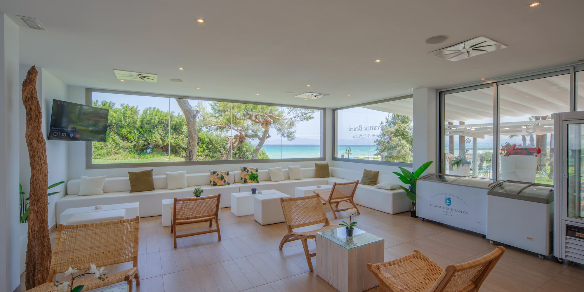 a room with white furniture and a large window