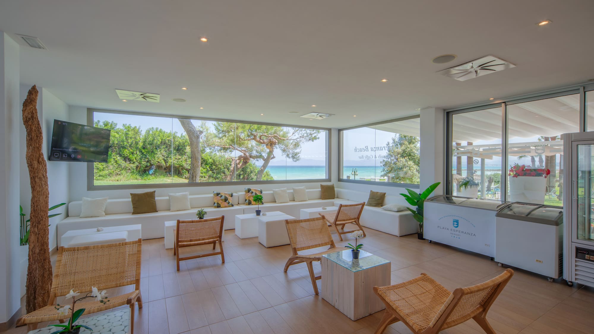a room with white furniture and a large window