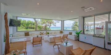 a room with white furniture and a large window