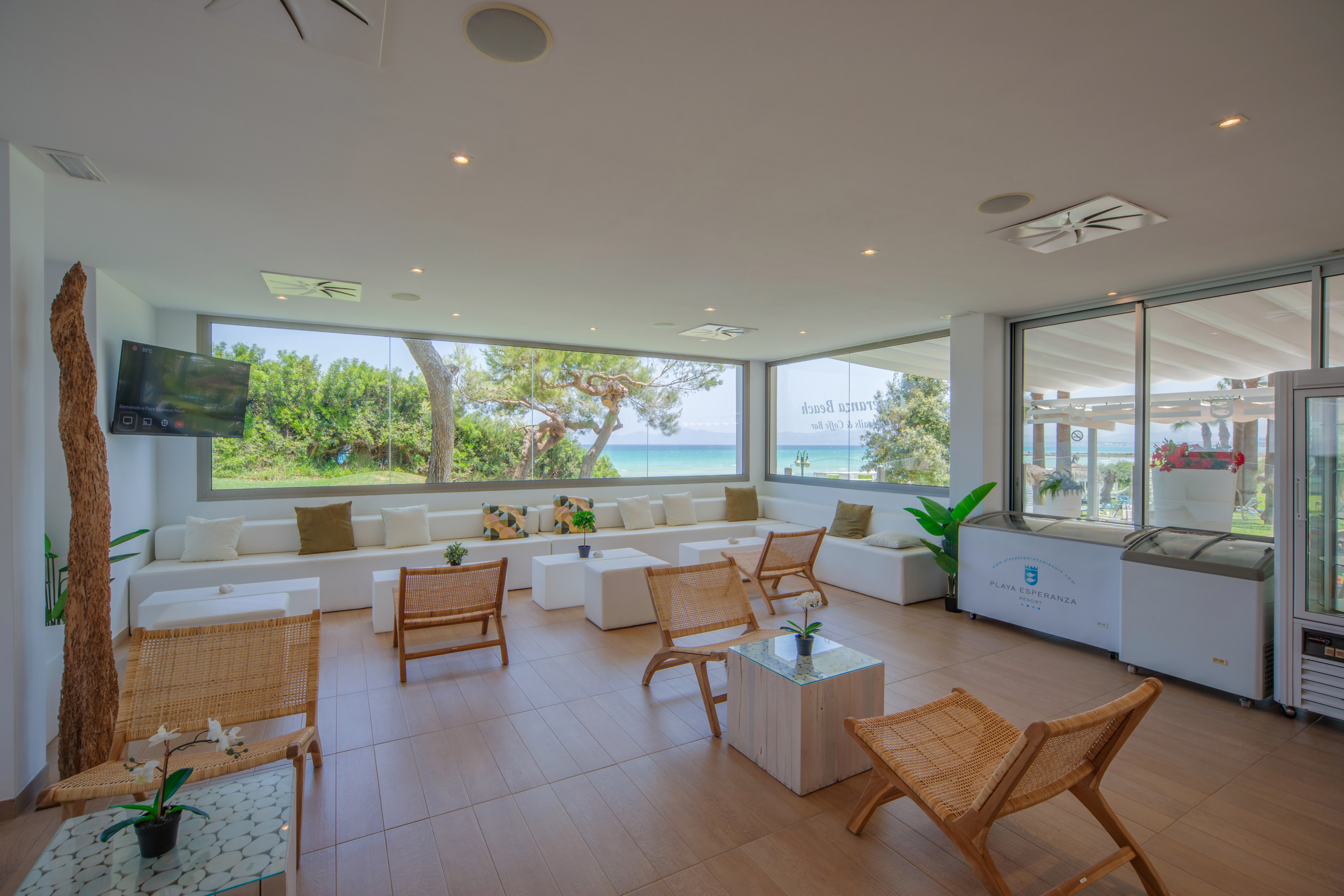 a room with white furniture and a large window