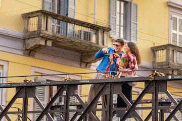 a man and woman standing on a bridge