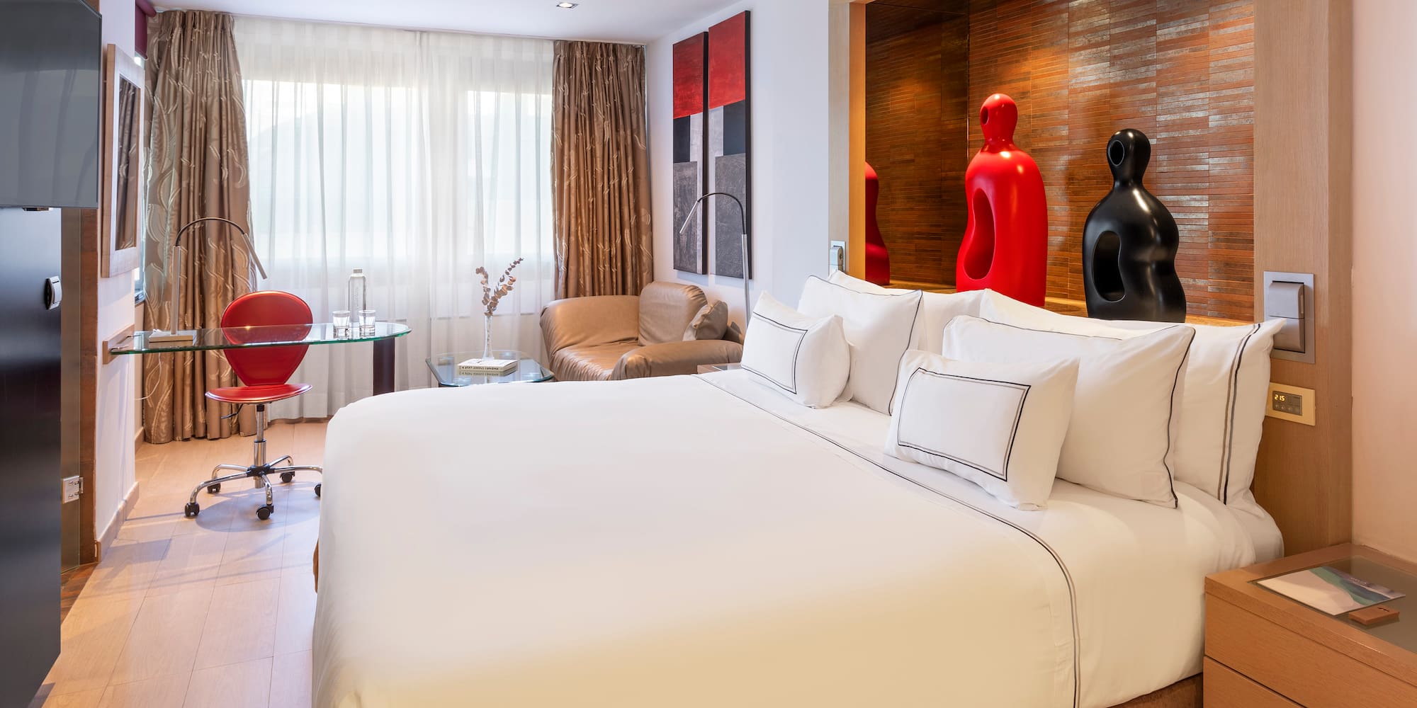 a room with a bed and a chair and a table