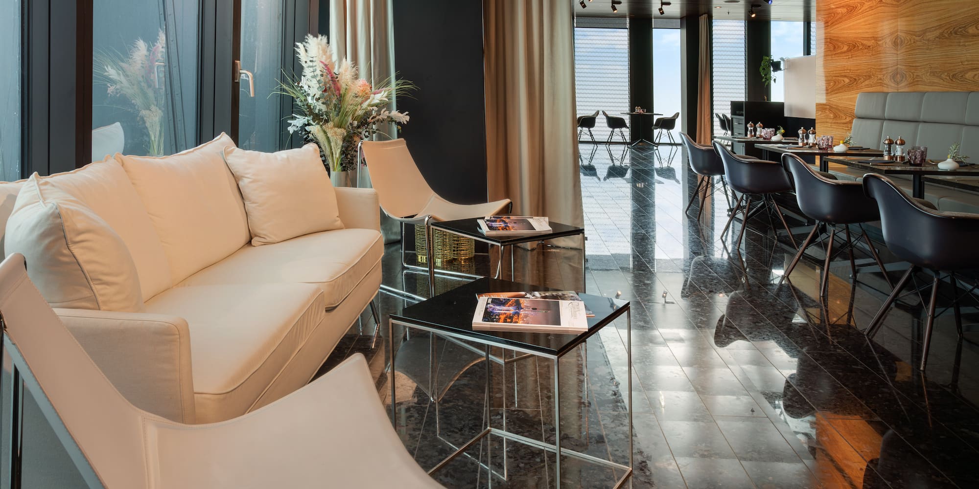 a room with a white couch and chairs