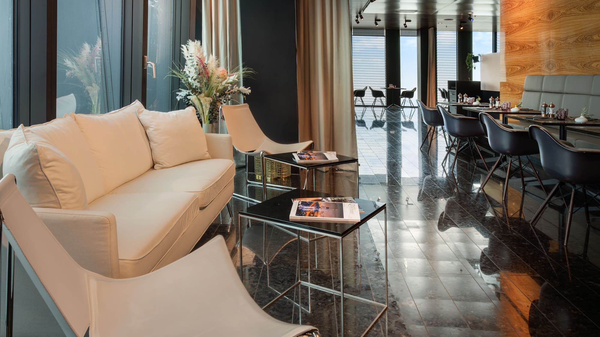 a room with a white couch and chairs