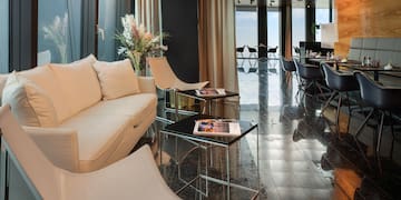 a room with a white couch and chairs