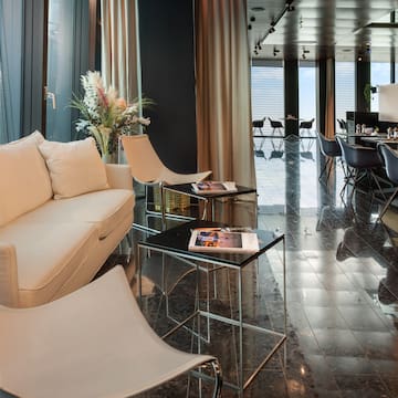 a room with a white couch and chairs