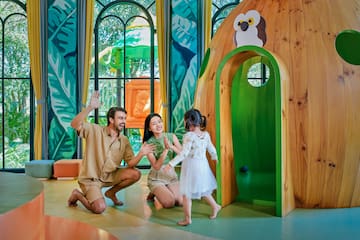 a man and woman with two children in a playroom