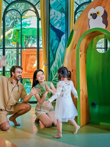 a man and woman with two children in a playroom