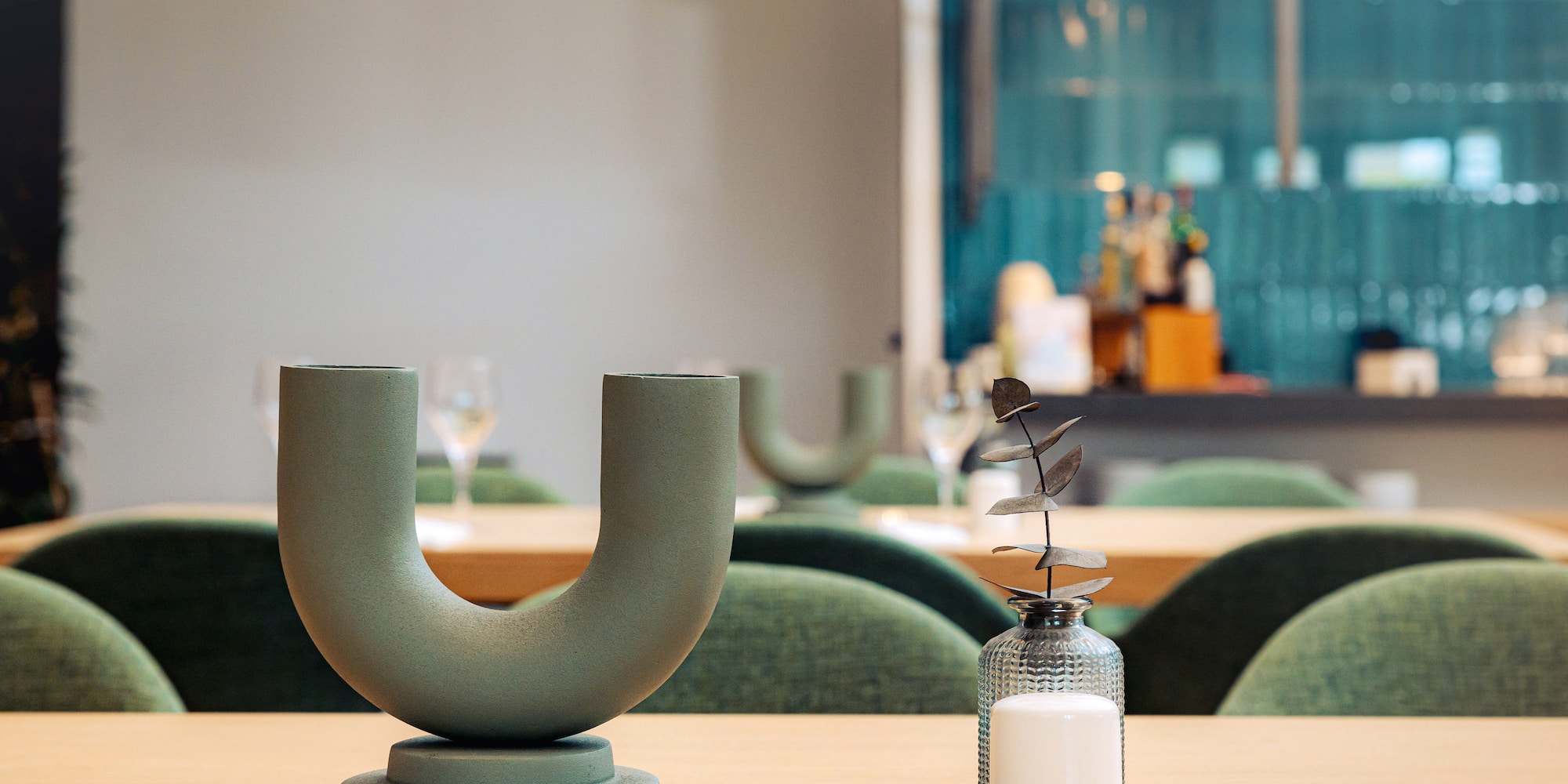 a candle and vase on a table