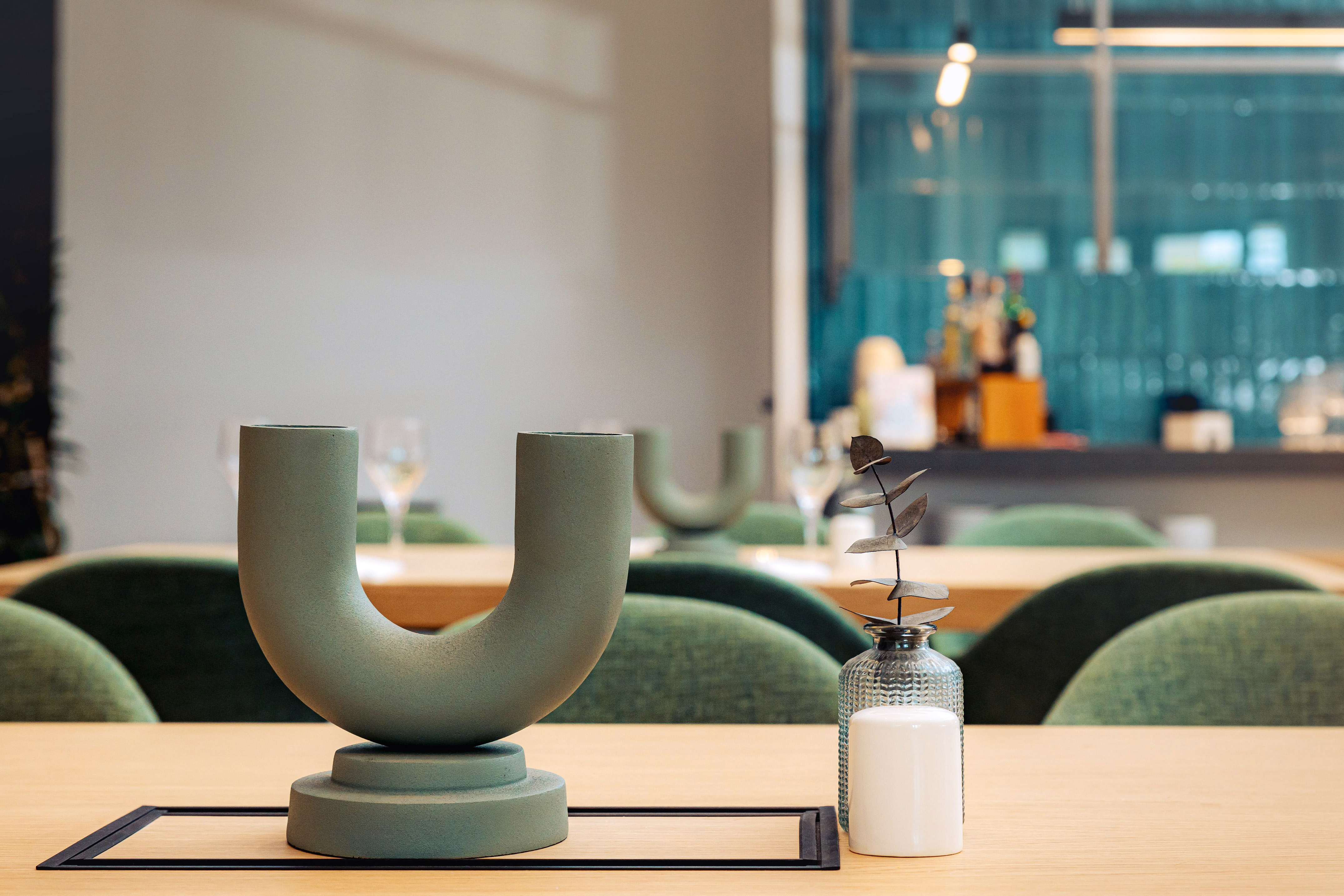 a candle and vase on a table