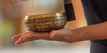 a person holding a singing bowl